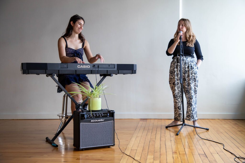 Arabella playing piano for a singer.